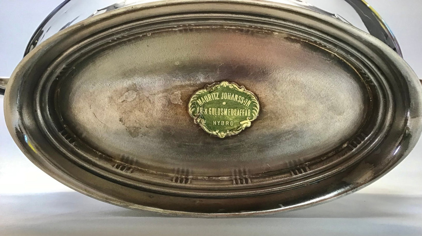 Metallic tray with a green logo on a white background