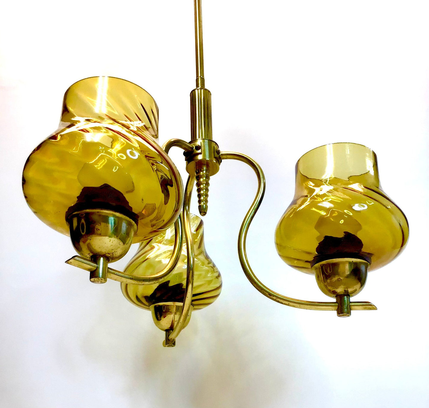 Gold chandelier with three candle-style lights on a white background