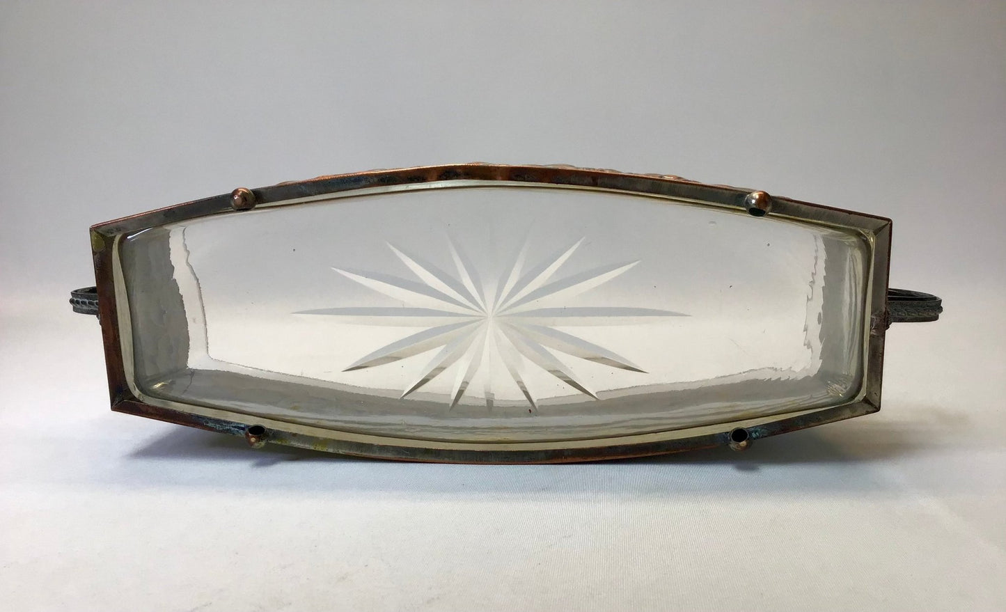 Decorative glass panel with starburst pattern on a white background