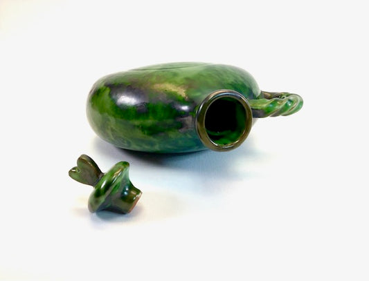 Green ceramic vase on a white background