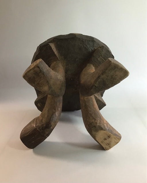 Wooden turtle figurine on a plain background