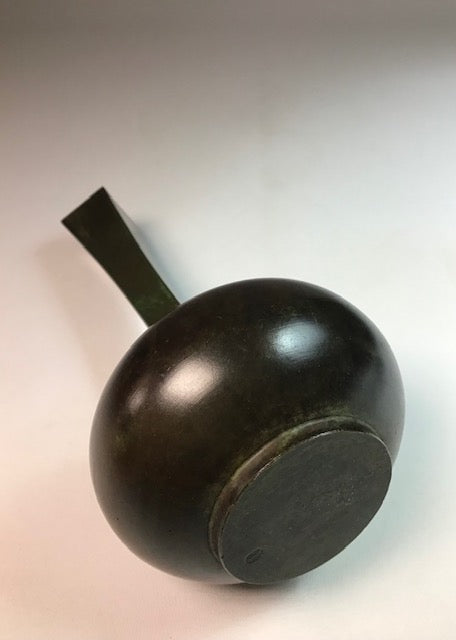 Wooden object with a handle on a light background