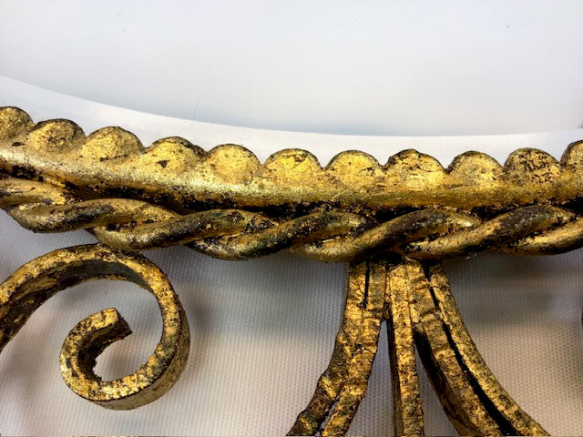 Decorative gold metal bracket on a white background