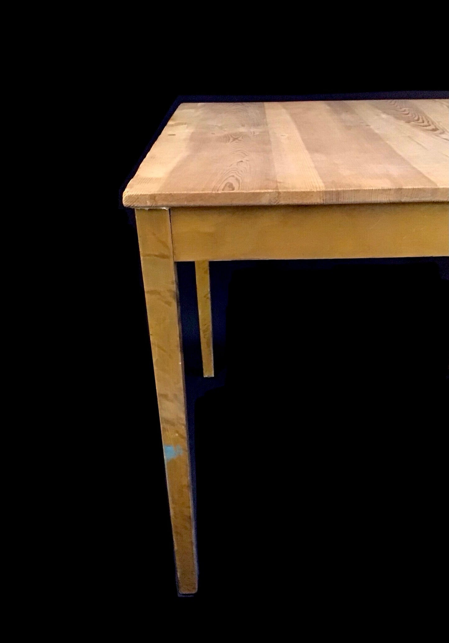 Wooden table with a dark background