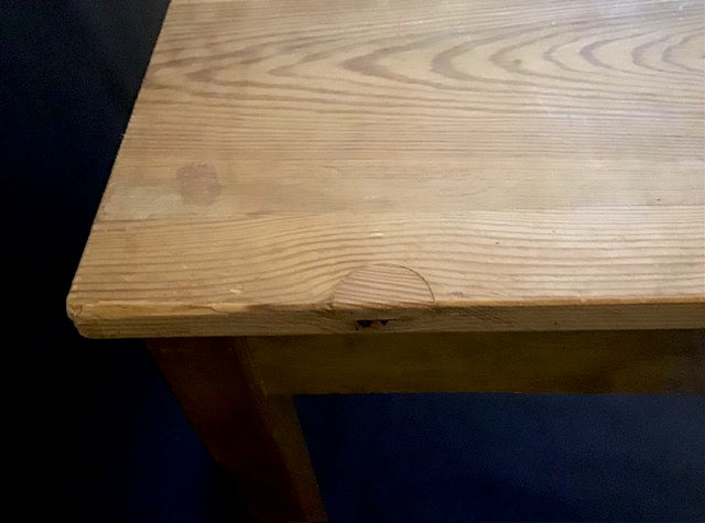 Close-up of a wooden surface with visible grain and texture.