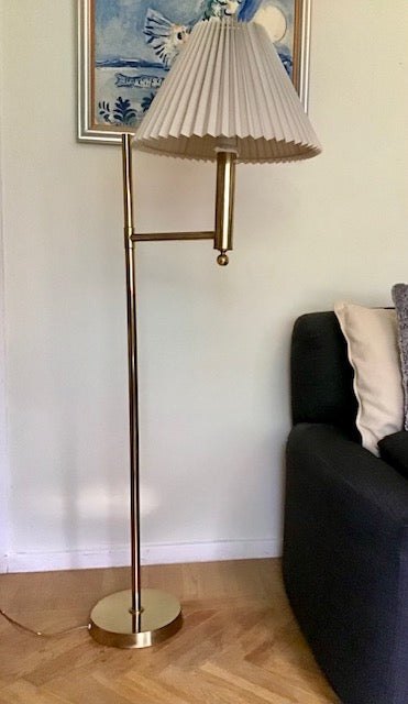 Floor lamp with pleated shade in a living room setting