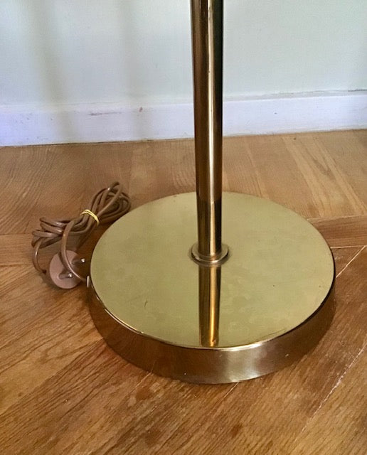 Gold floor lamp base on a wooden floor