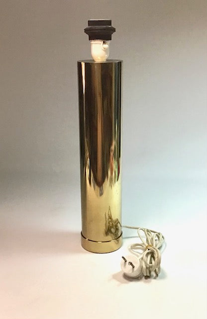 Gold cylindrical lamp with a light bulb on a neutral background