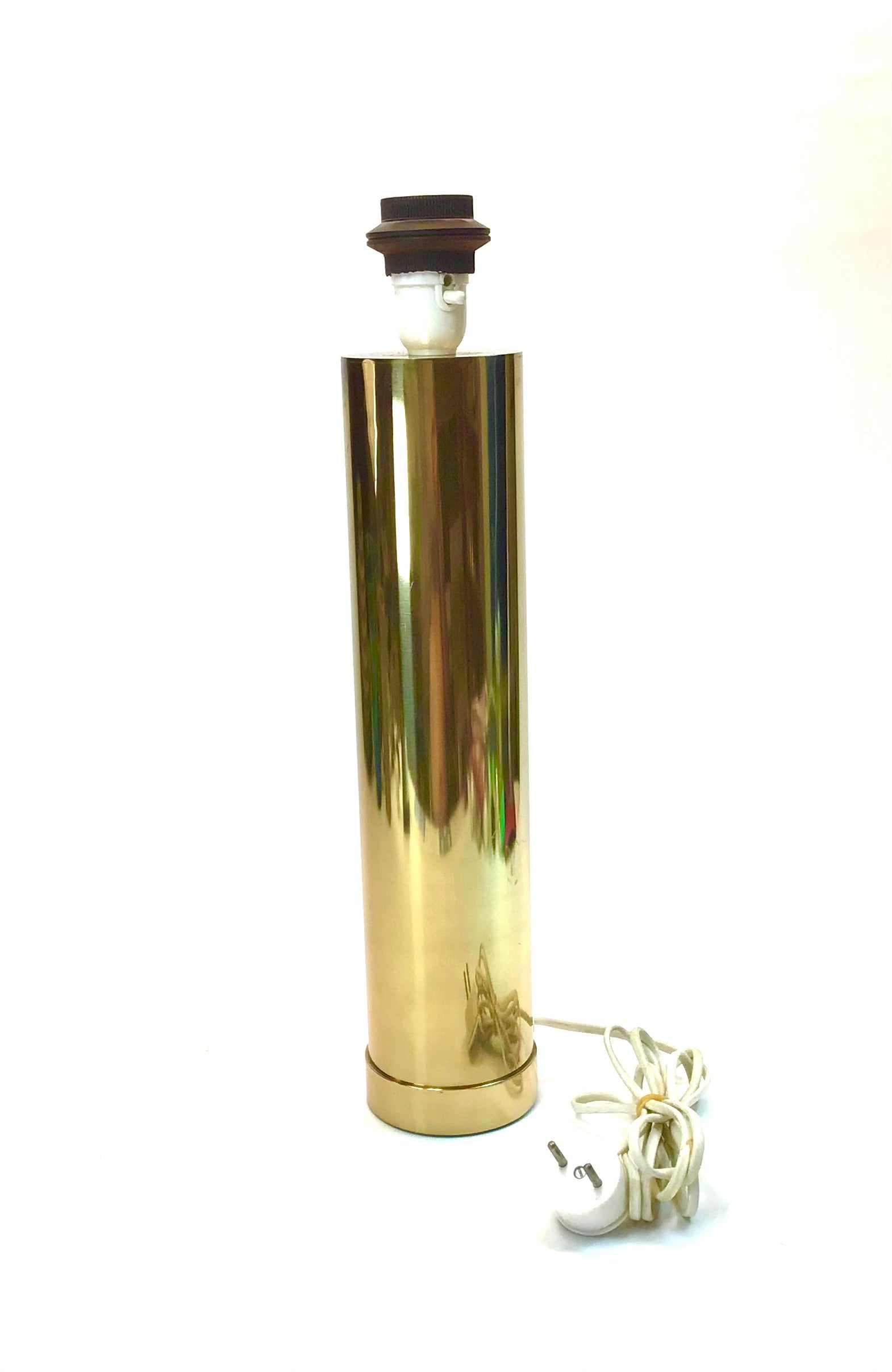 Gold cylindrical lamp with a white bulb on a white background