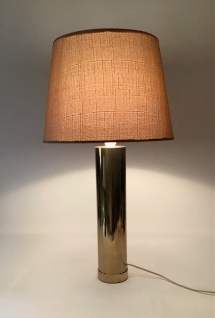 Table lamp with a brown lampshade on a neutral background