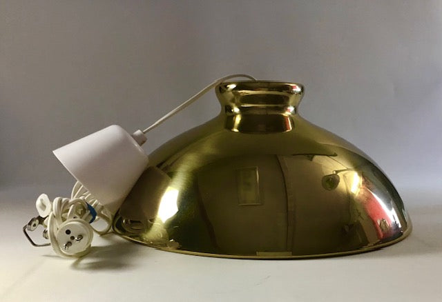 Gold pendant light fixture on a plain background