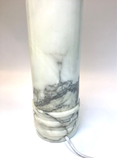 Marble-patterned cylindrical object on a white background