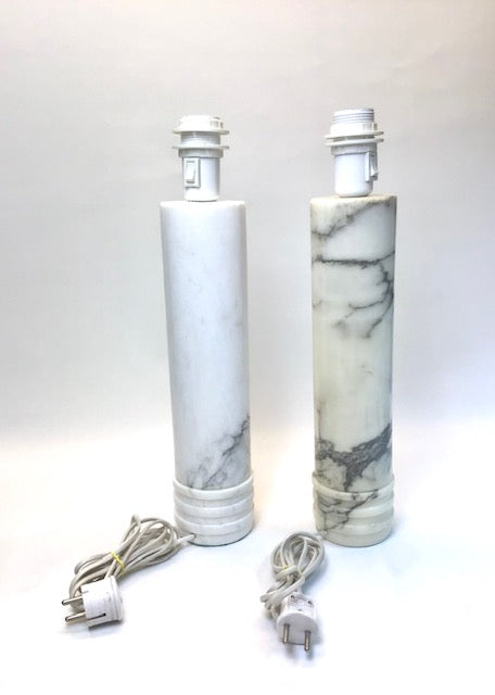 Two cylindrical marble-patterned light fixtures with cords on a white background