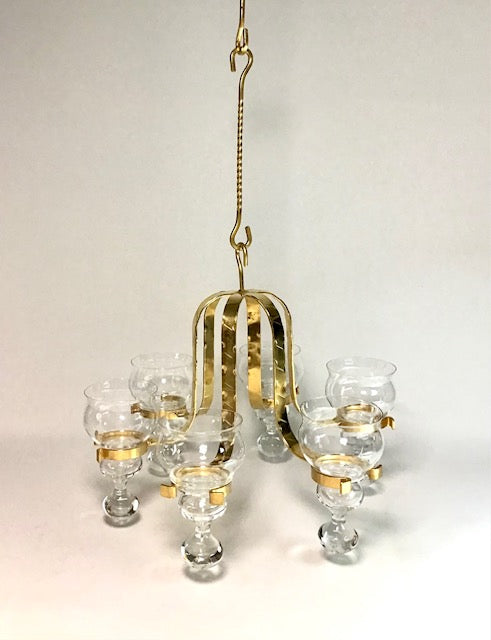 Gold and clear glass chandelier on a plain background