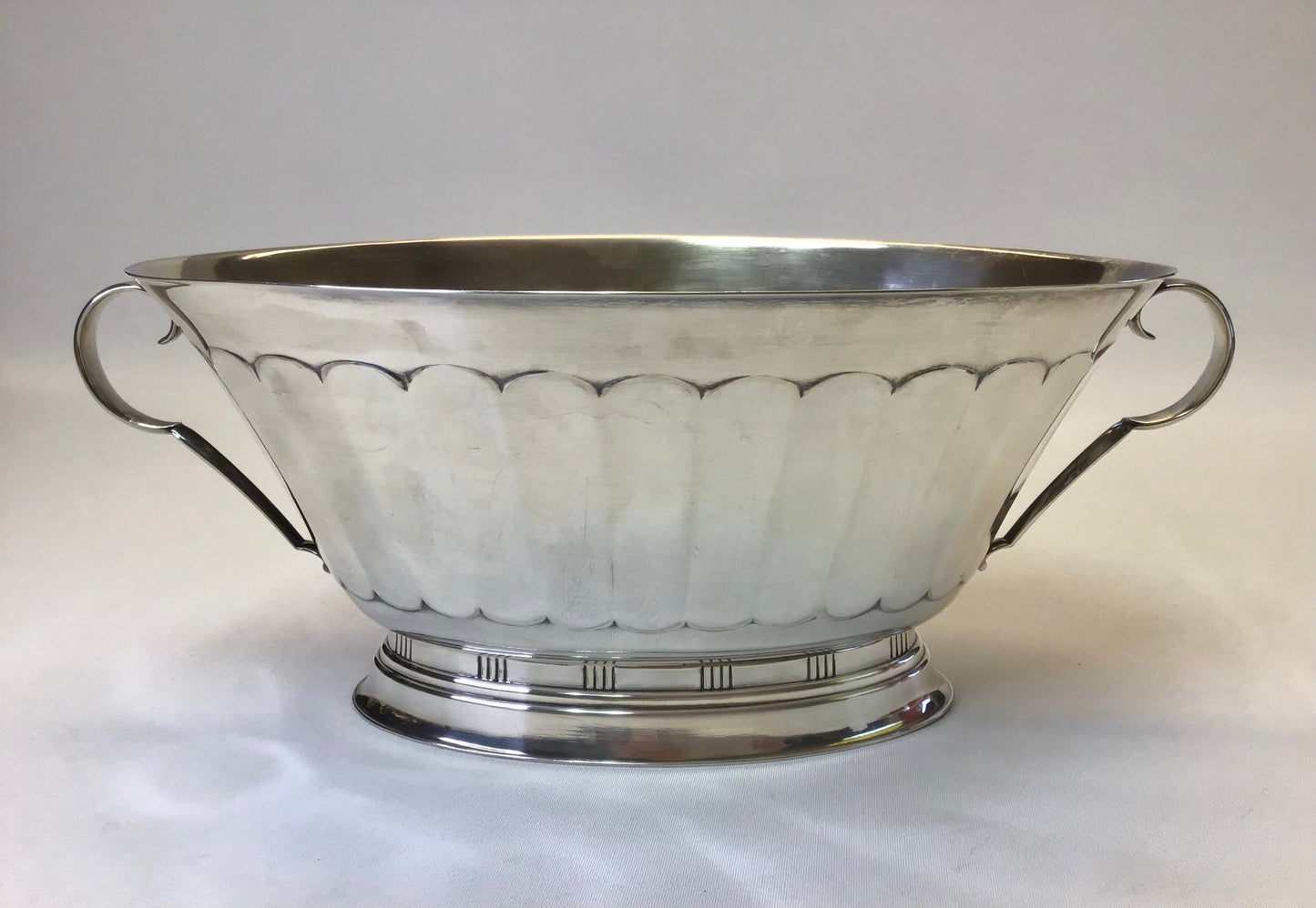 Silver bowl with handles on a white background