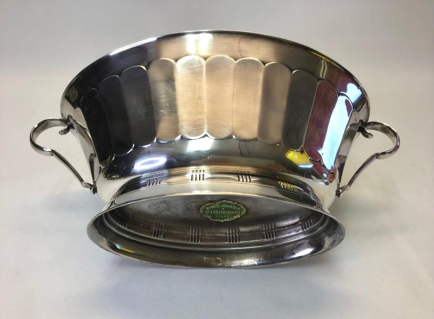 Stainless steel pot with handles on a white background