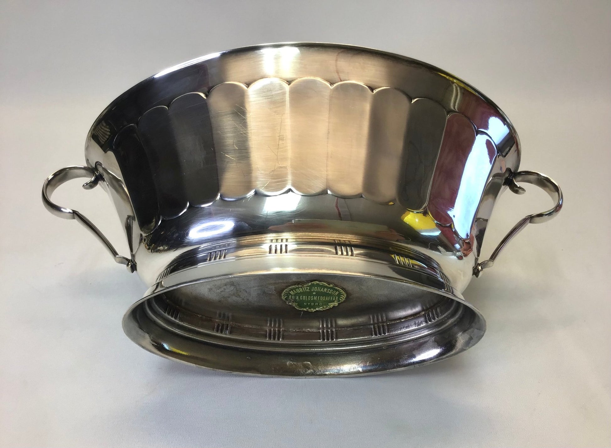 Stainless steel pot with handles on a white background