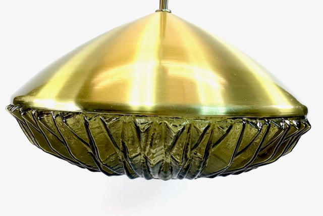 Gold pendant light with textured glass shade on a white background