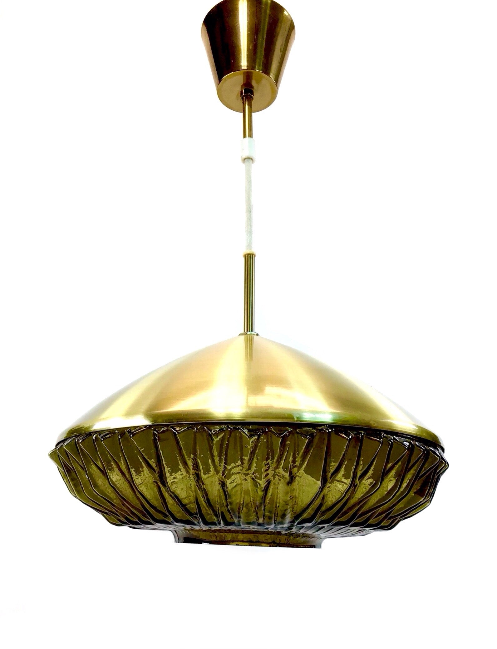 Gold pendant light with a textured green glass shade on a white background