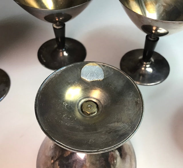 Close-up of metallic objects with a central focus on a shiny, reflective surface.