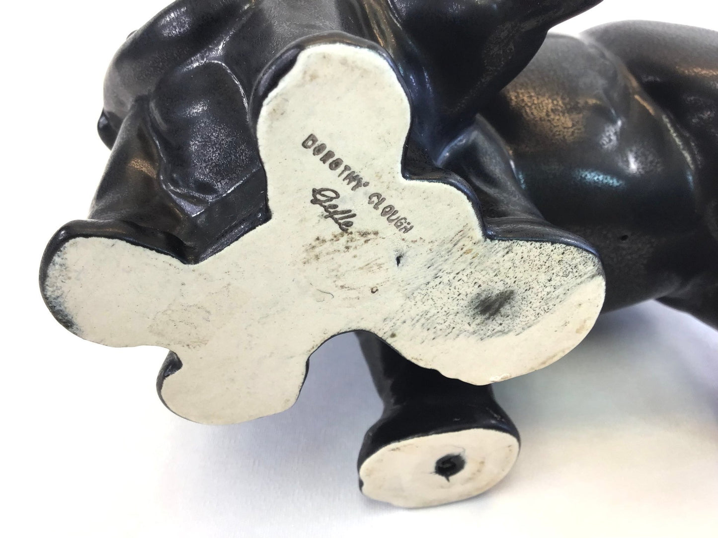 Close-up of a black and white shoe with 'Cody's Clouga' branding on a white background