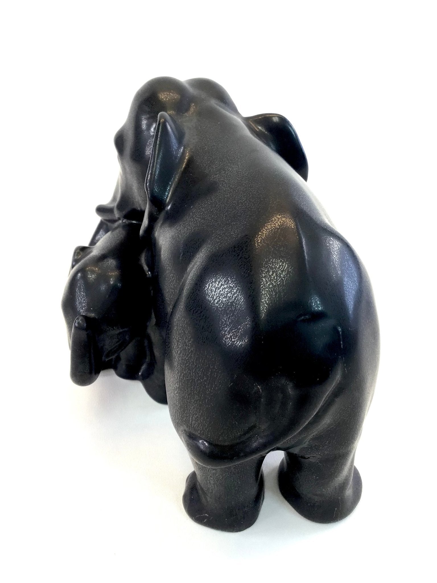 Black ceramic bear figurine on a white background