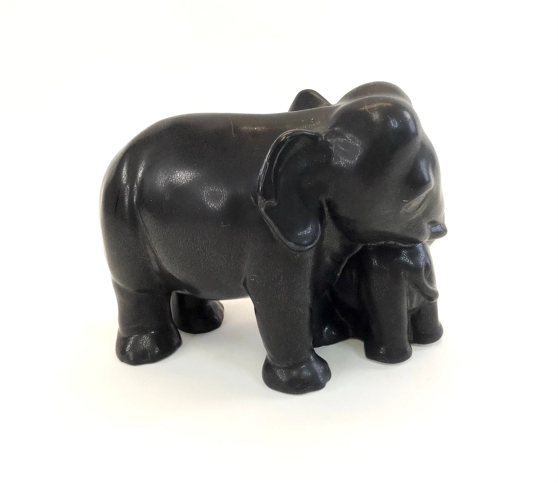 Black elephant figurine on a white background