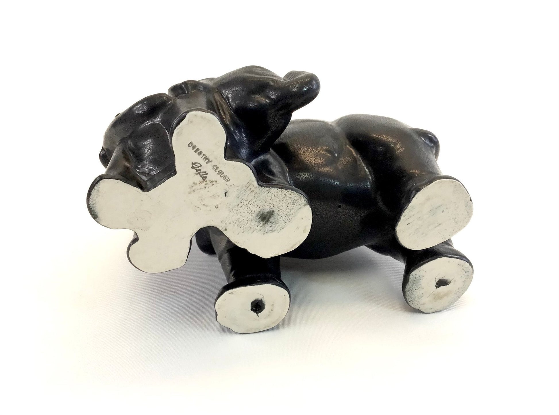 Black and white ceramic cow figurine on a white background