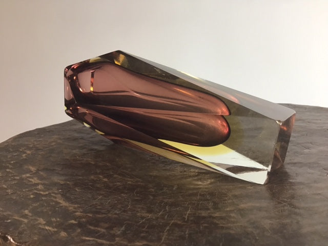Crystal-like object with a reflective surface on a textured surface