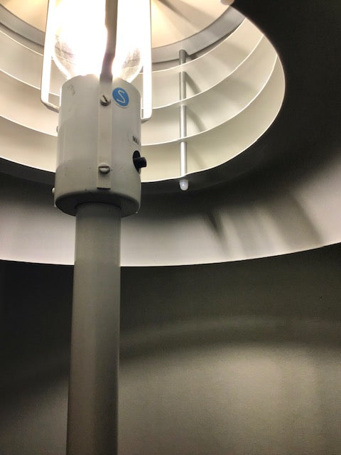 Ceiling light fixture with spiral design in the background