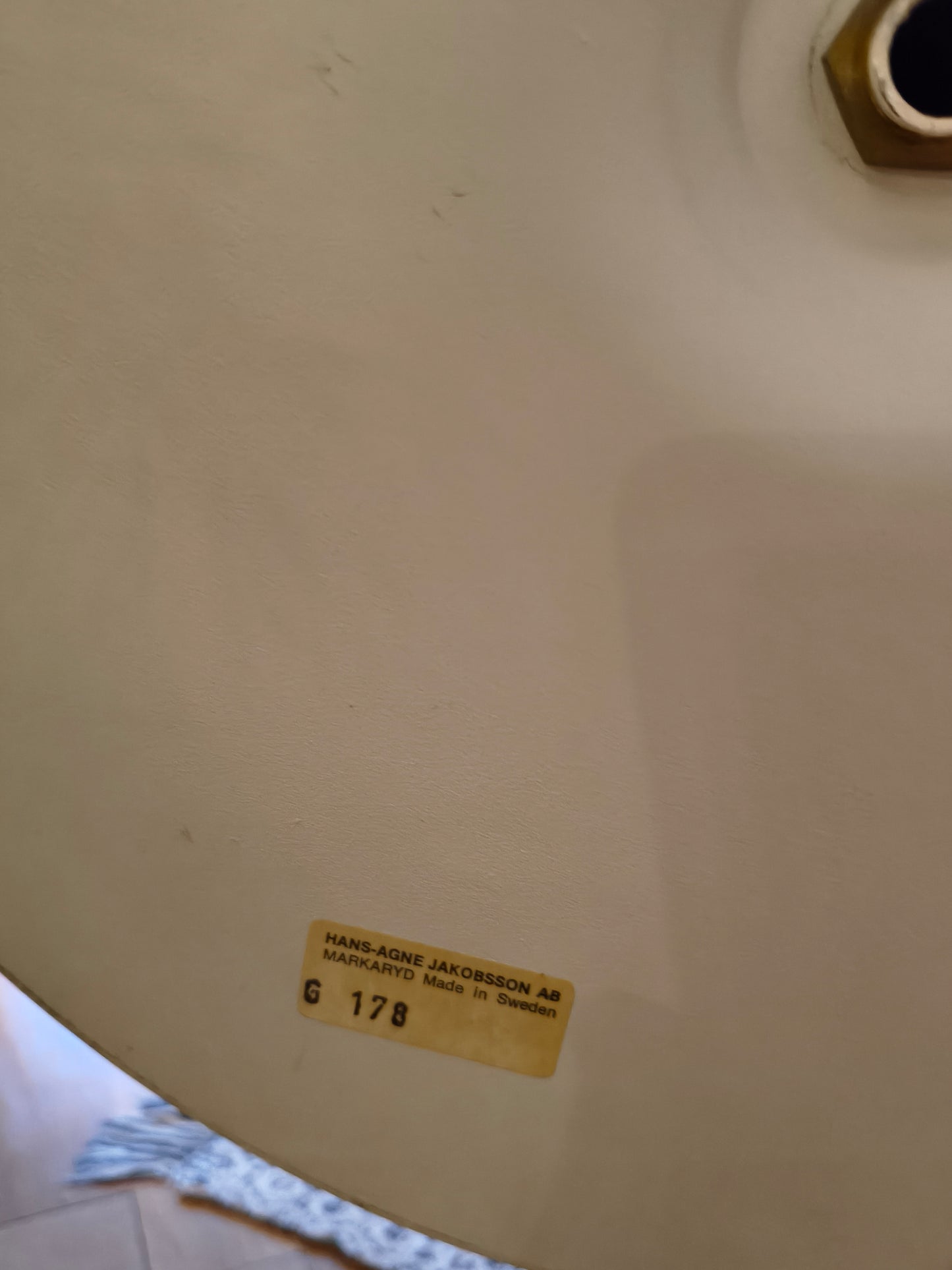Beige chair with a label on a beige background
