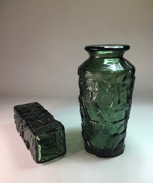 Two green textured glass vases on a white background