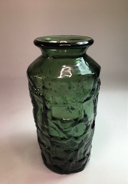 Green textured vase on a light background