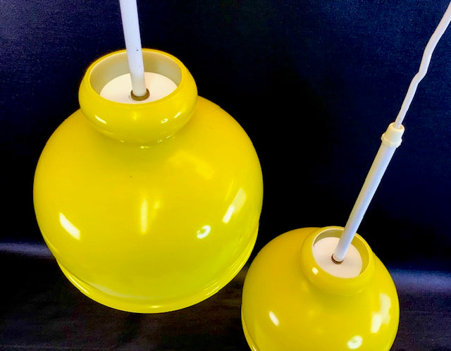 Two yellow hanging lights against a dark background