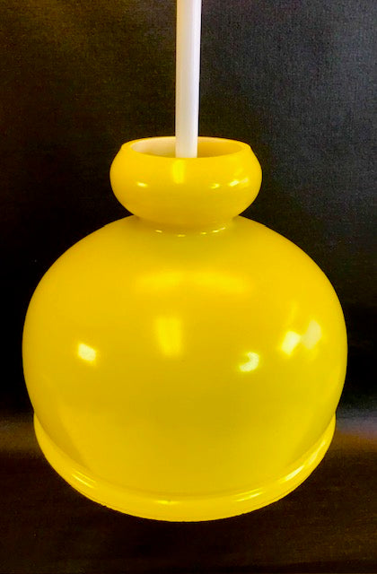 Yellow glass apple on a black background