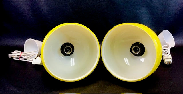 Two yellow speakers with white centers on a dark background