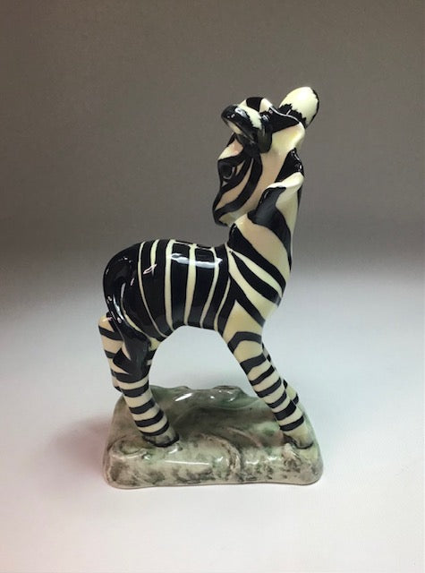 Zebra figurine on a plain background