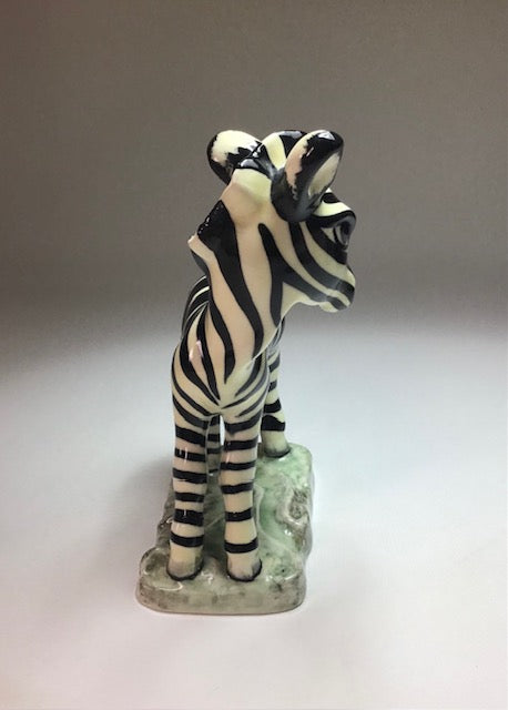 Zebra figurine on a light gray background