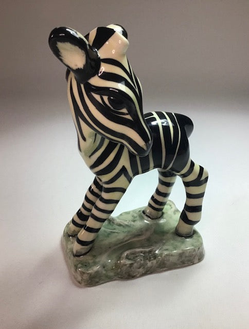 Ceramic zebra figurine on a white background
