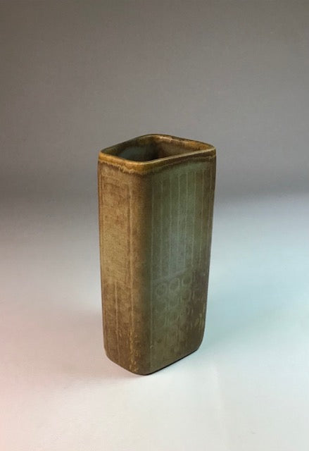 Rectangular ceramic vase with a textured surface on a gradient background
