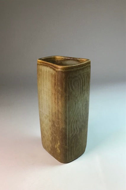 Rectangular ceramic vase with textured surface on a gradient background