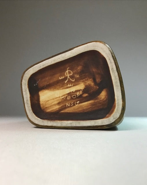 Wooden box with engraved text on a gray background