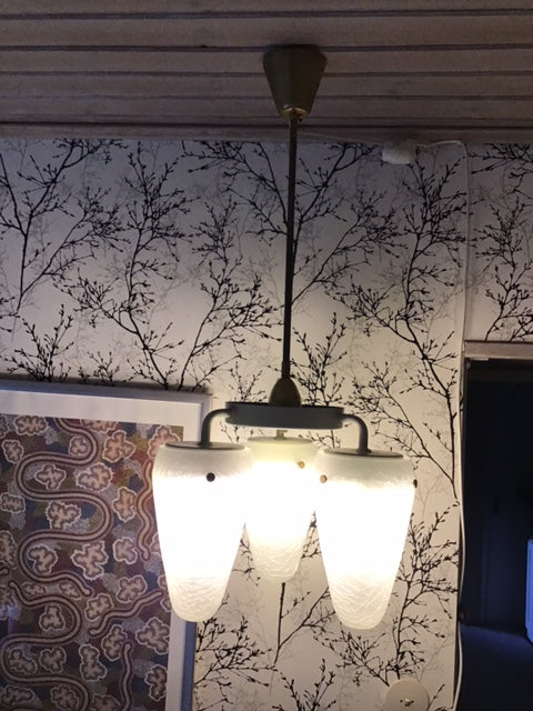 Floor lamp with a white shade on a patterned rug
