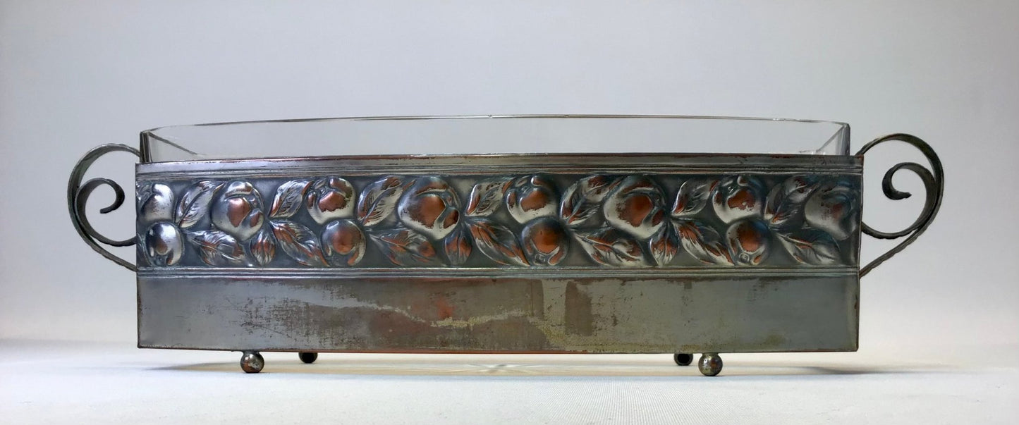 Decorative metal tray with floral patterns on a white background