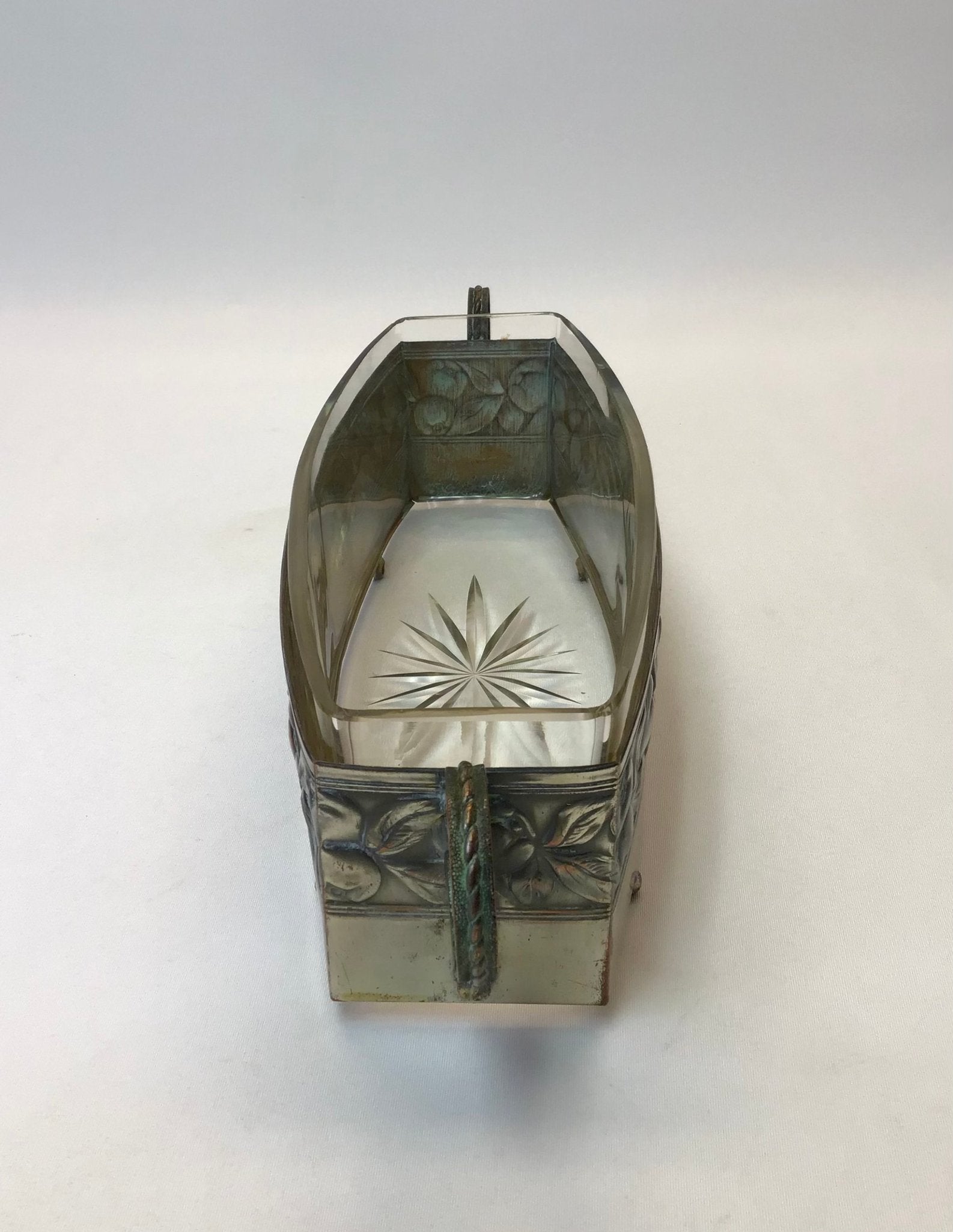 Decorative wall sconce with intricate designs on a white background