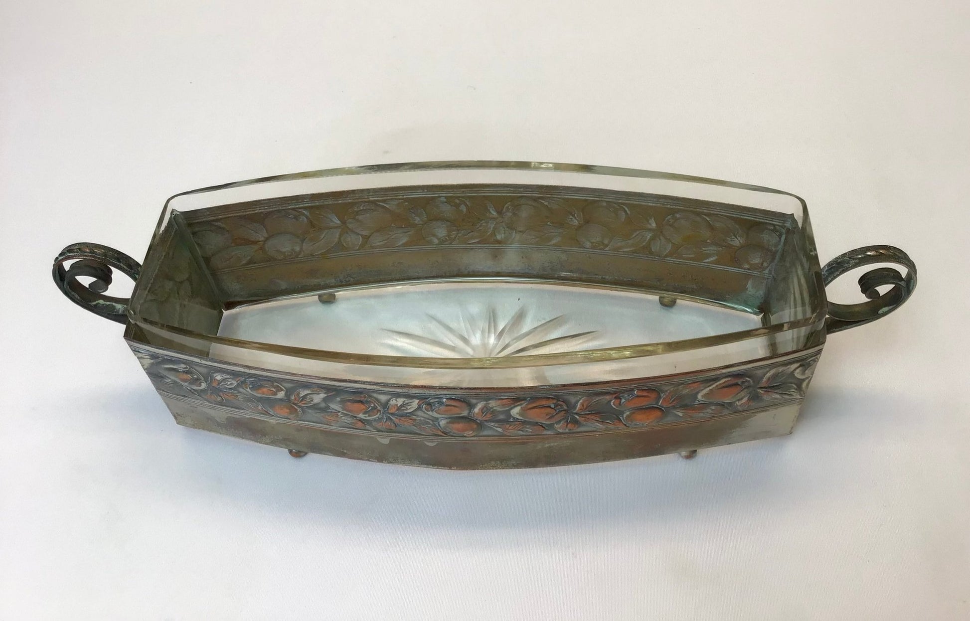 Decorative metal tray with glass lid on a white background