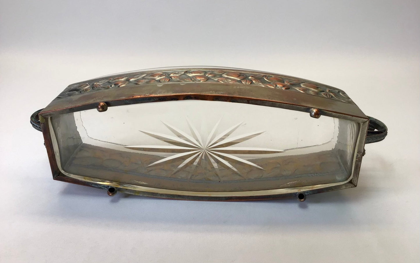 Decorative glass tray with metal frame on a white background