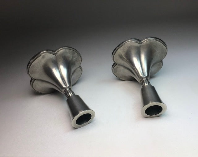 Two metallic funnel-shaped objects on a gradient background