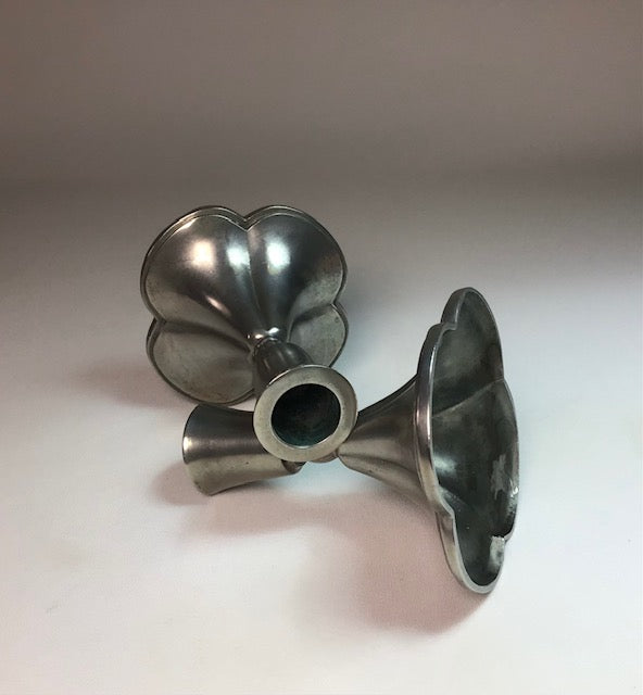 Metallic funnel-shaped objects on a white background