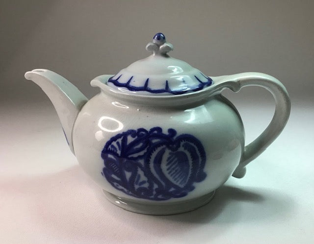 White teapot with blue floral patterns on a white background